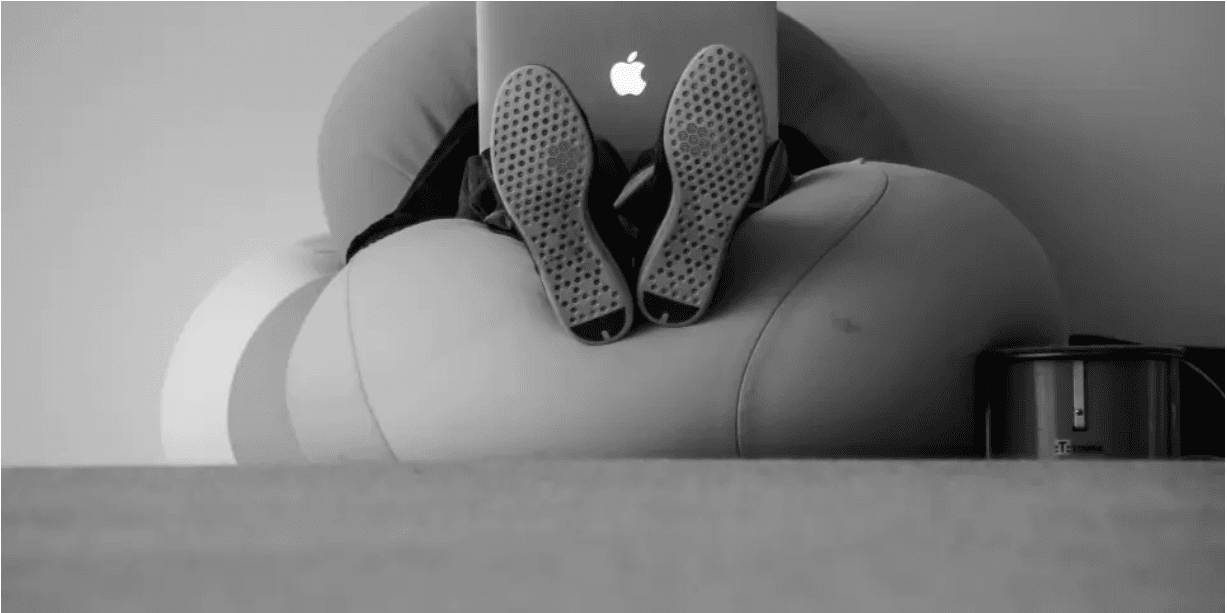 Professional working from a sculptural chair with a laptop